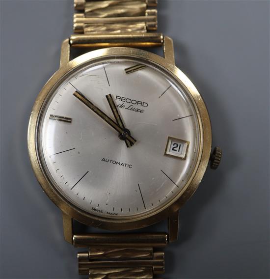 A gentlemans late 1960s 9ct gold Record de Luxe automatic wrist watch, on an associated 9ct gold strap, gross 47 grams,